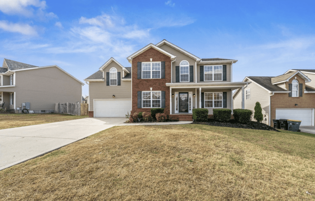 Modern two-story house with brick and siding exterior and a spacious driveway.