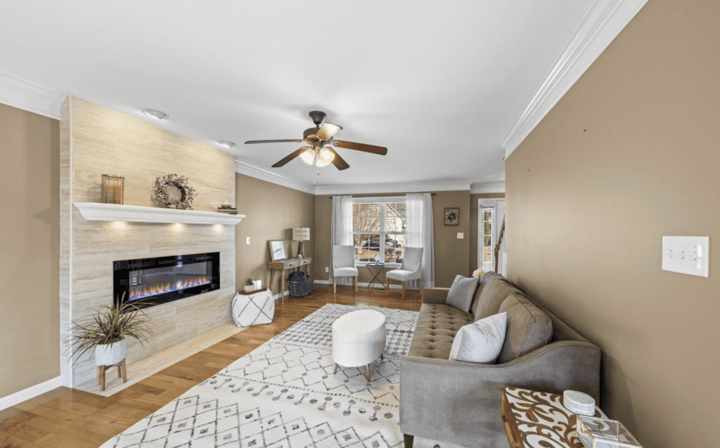 Modern living room with cozy seating and fireplace.