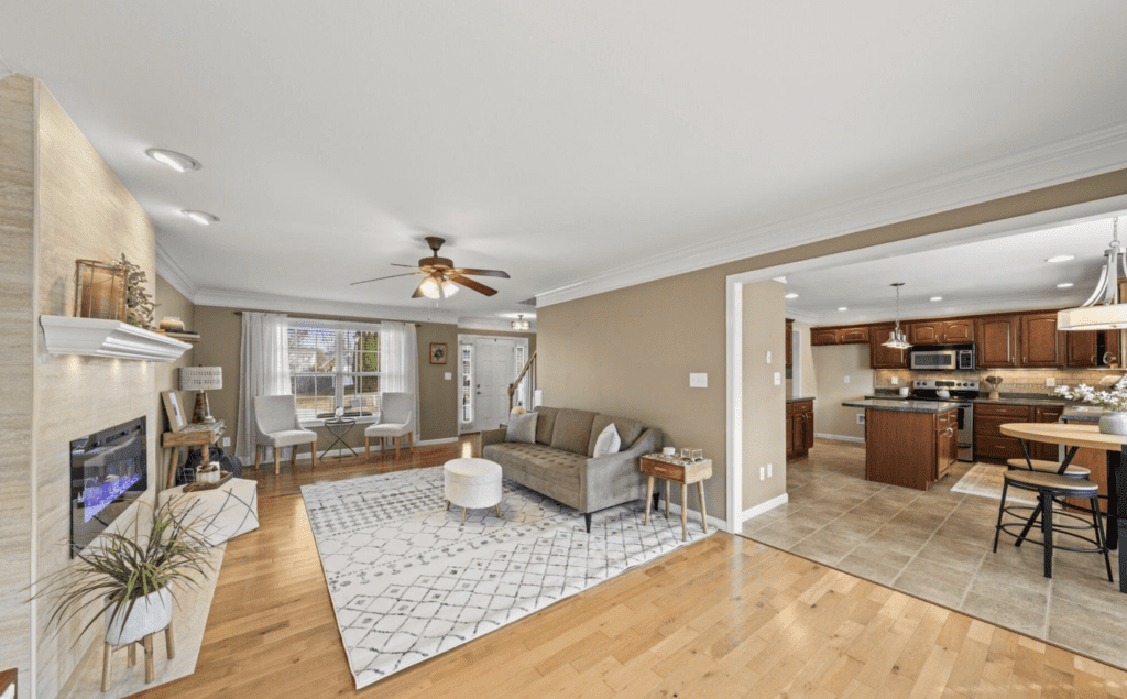 Spacious living room with modern furniture and a ceiling fan.