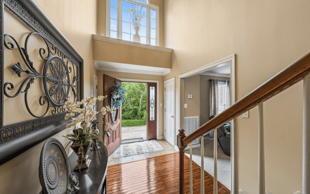 Bright and welcoming entryway with open door and natural light.