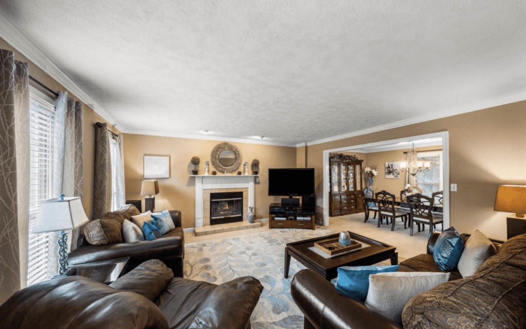 Spacious living room with cozy fireplace and elegant decor.