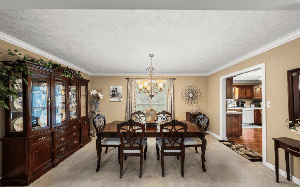 Elegant dining room with wooden furniture and a chandelier.