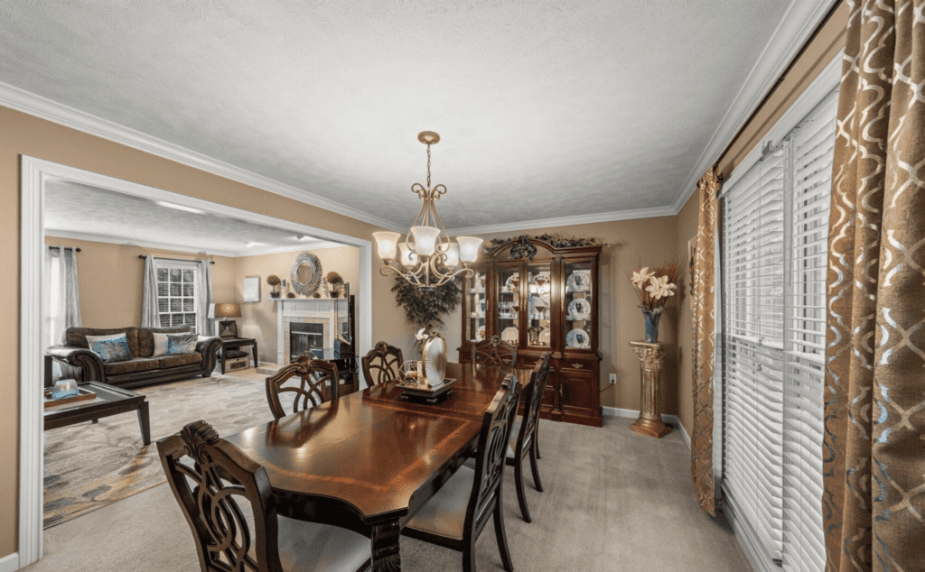 Elegant dining room with classic wooden furniture and chandelier.