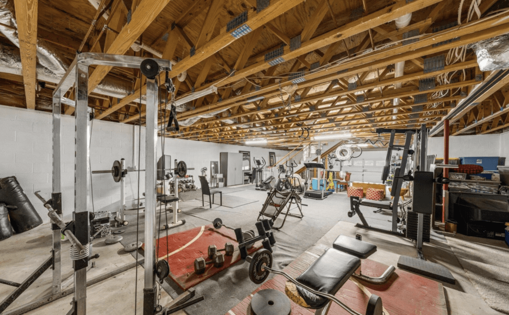 A spacious home gym with various exercise machines and equipment.