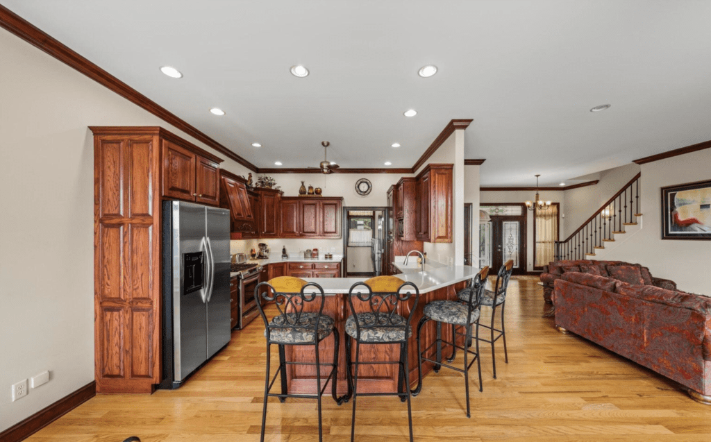 Spacious kitchen with wooden cabinetry and a large island with seating.