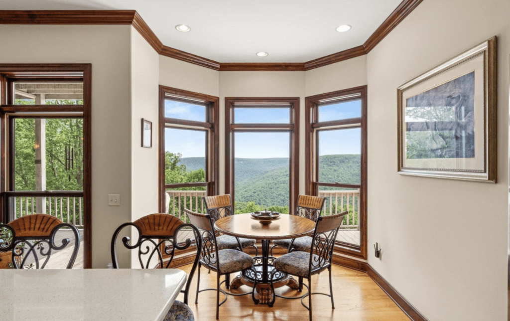Bright dining area with large windows and scenic mountain views.