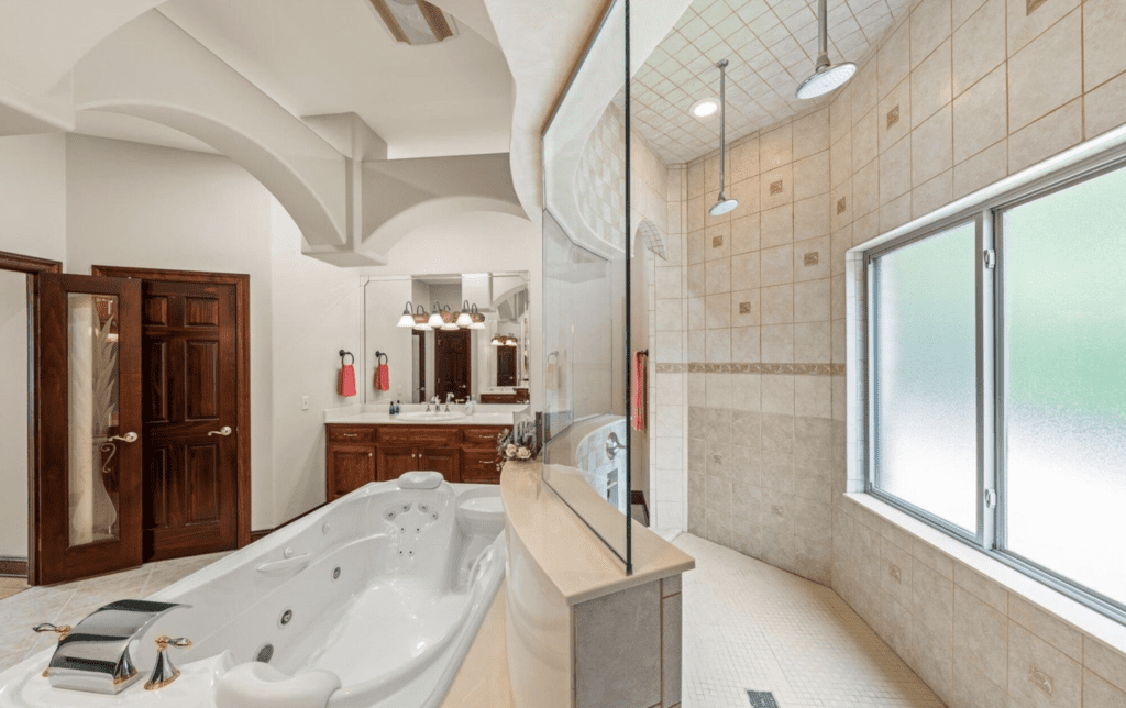 Elegant bathroom with a large bathtub and spacious walk-in shower.