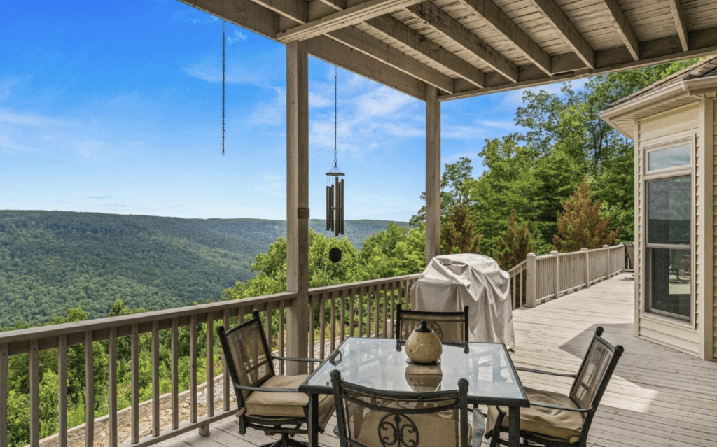 Scenic outdoor deck with mountain views and cozy seating.