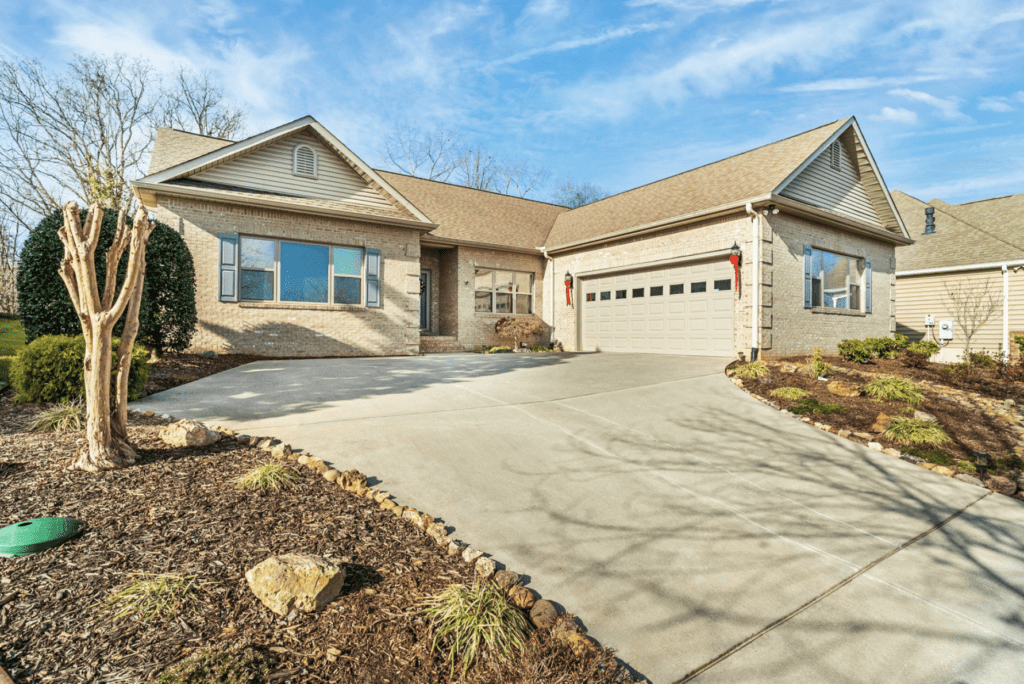 Modern single-story house with a spacious driveway and attached garage.