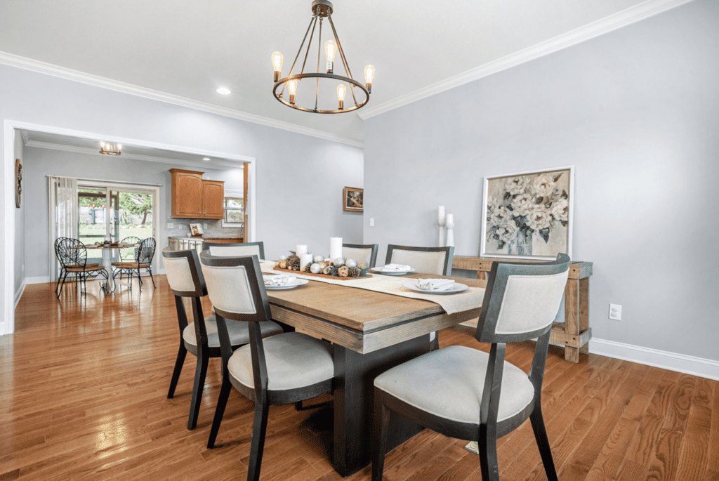 Elegant dining room with modern chairs and a chandelier.