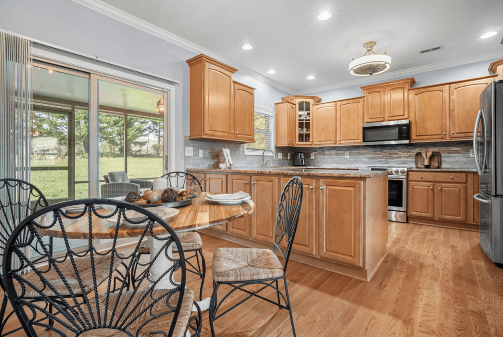 Bright kitchen with wooden cabinets and an island in the center.
