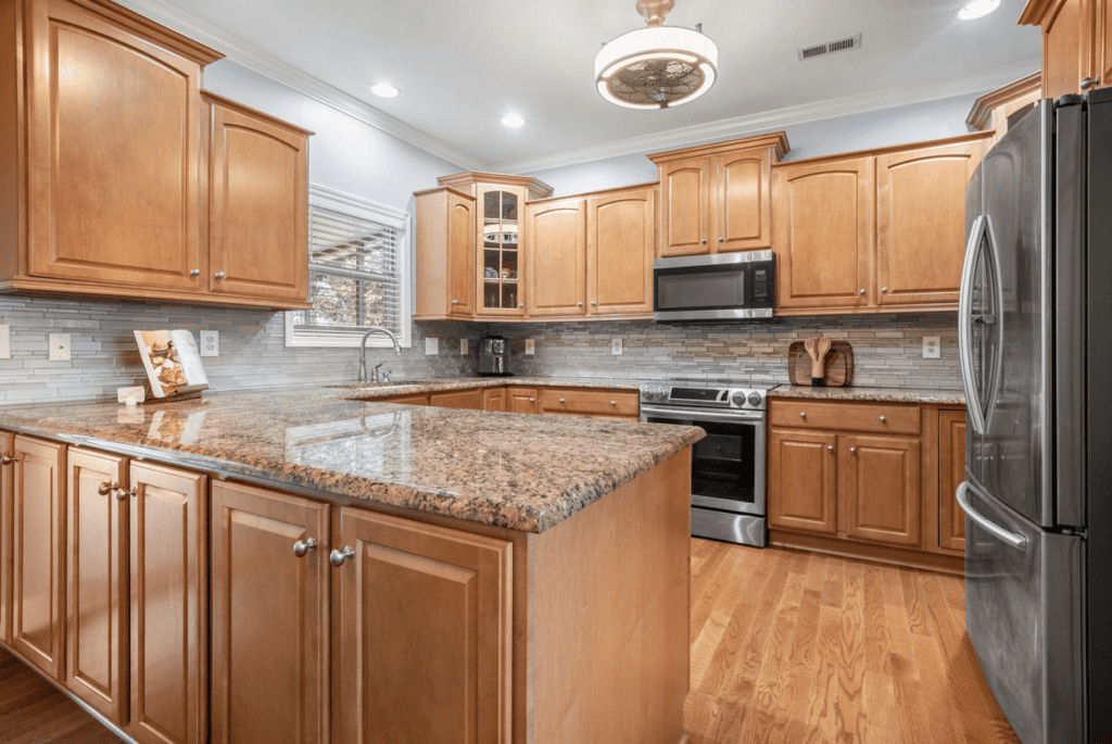 Spacious kitchen with wooden cabinets and granite countertops.