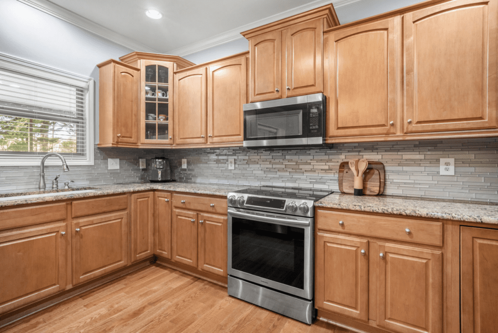 Modern kitchen with wooden cabinets and stainless steel appliances.