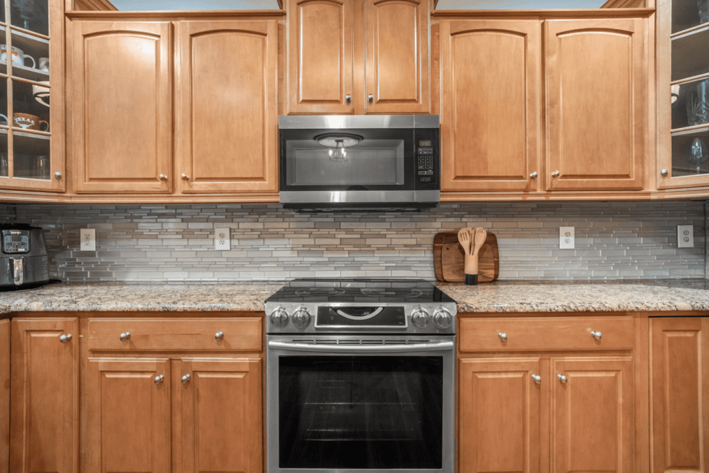Modern kitchen with wooden cabinets and stainless steel appliances.