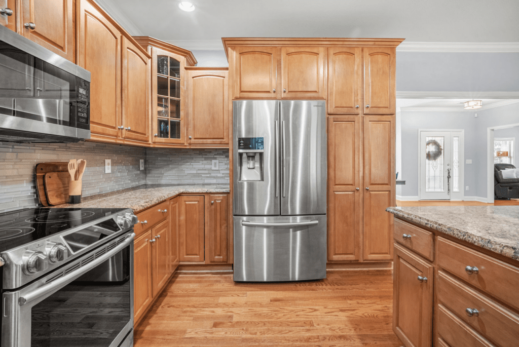 Modern kitchen with wooden cabinets and stainless steel appliances.