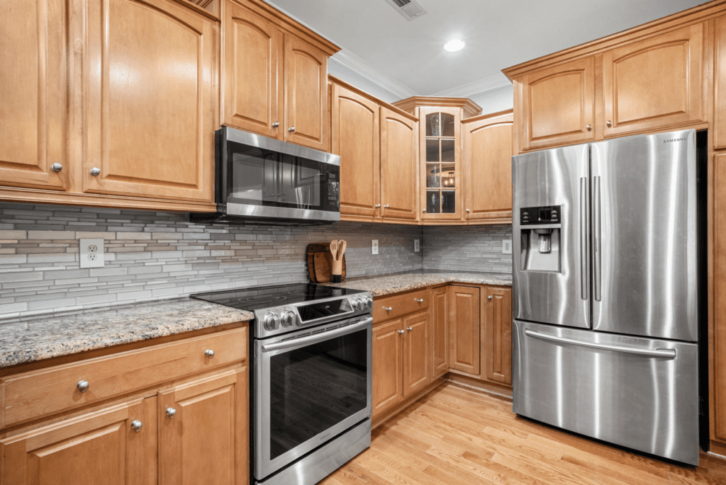 Modern kitchen with wooden cabinets and stainless steel appliances.