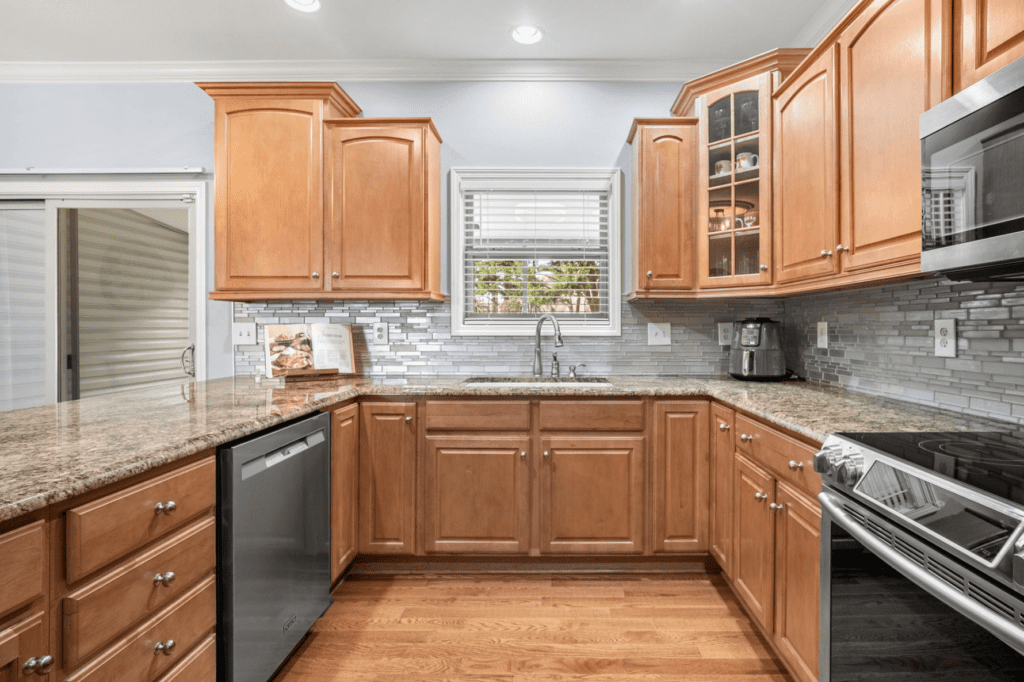 Modern kitchen with wooden cabinets and stainless steel appliances.