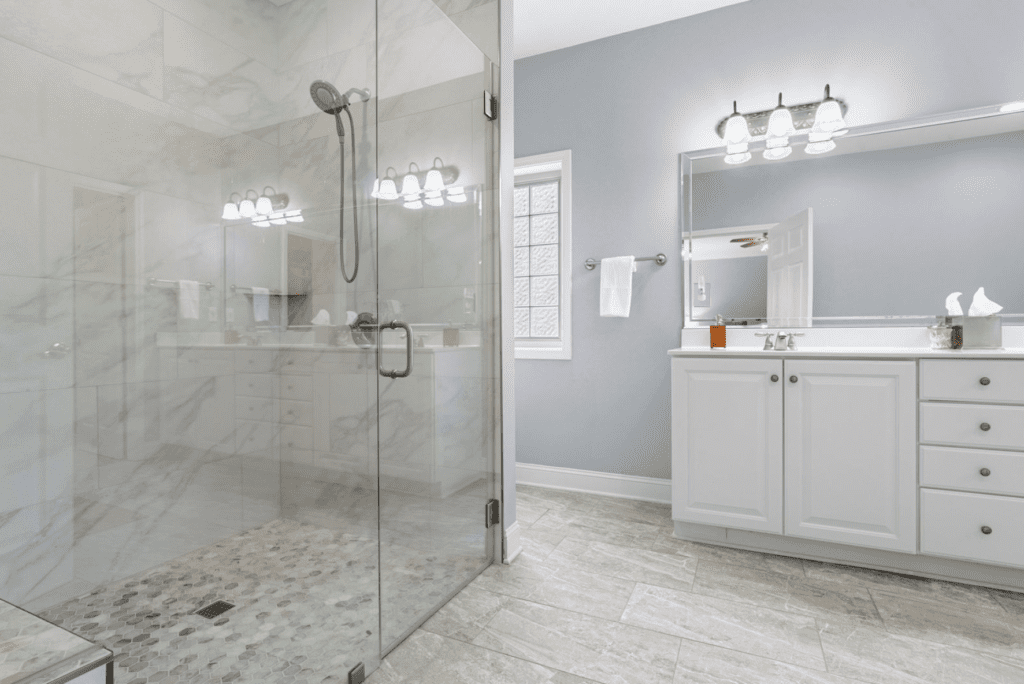 Modern bathroom with glass shower and white vanity.