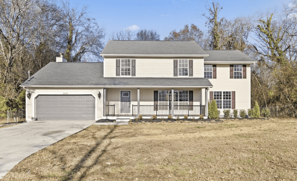A two-story suburban house with a front porch and garage.