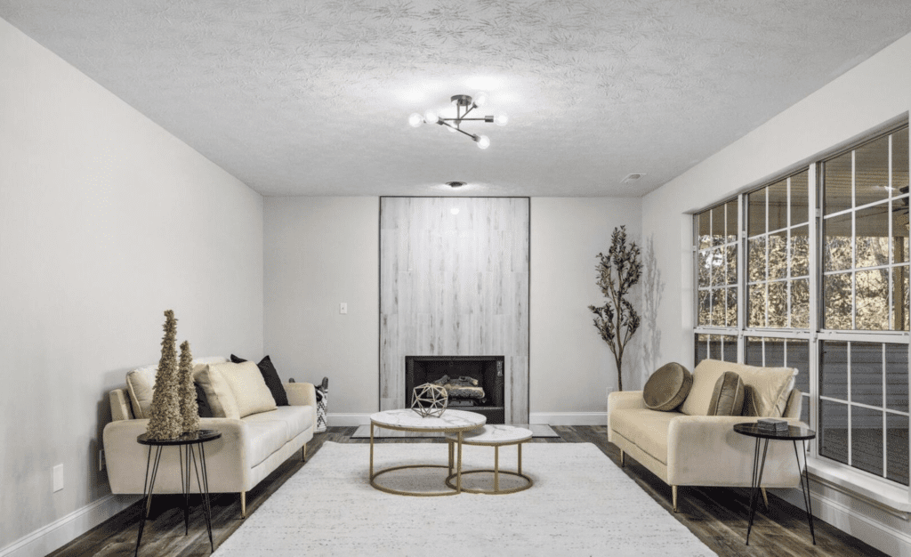 Modern living room with neutral tones and gold accents.