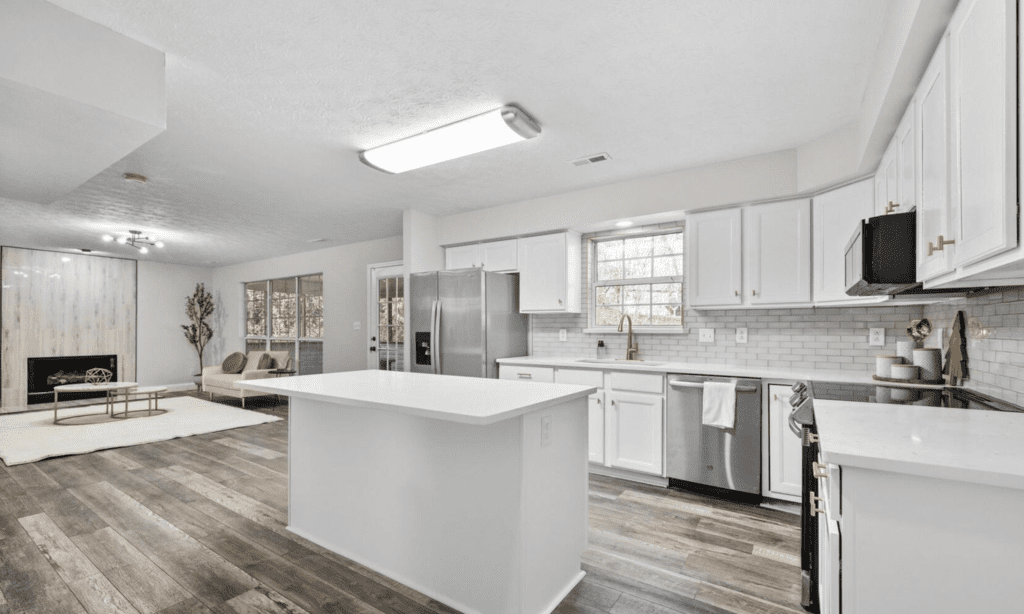 Bright modern kitchen with white cabinets and island.