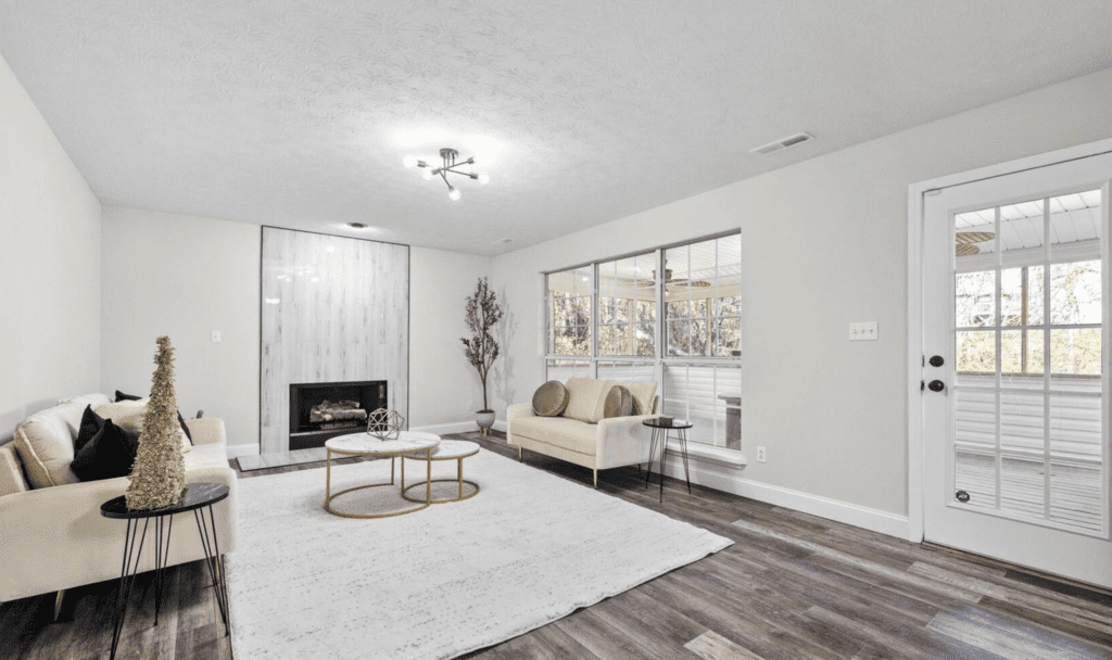Modern living room with large windows and cozy seating.