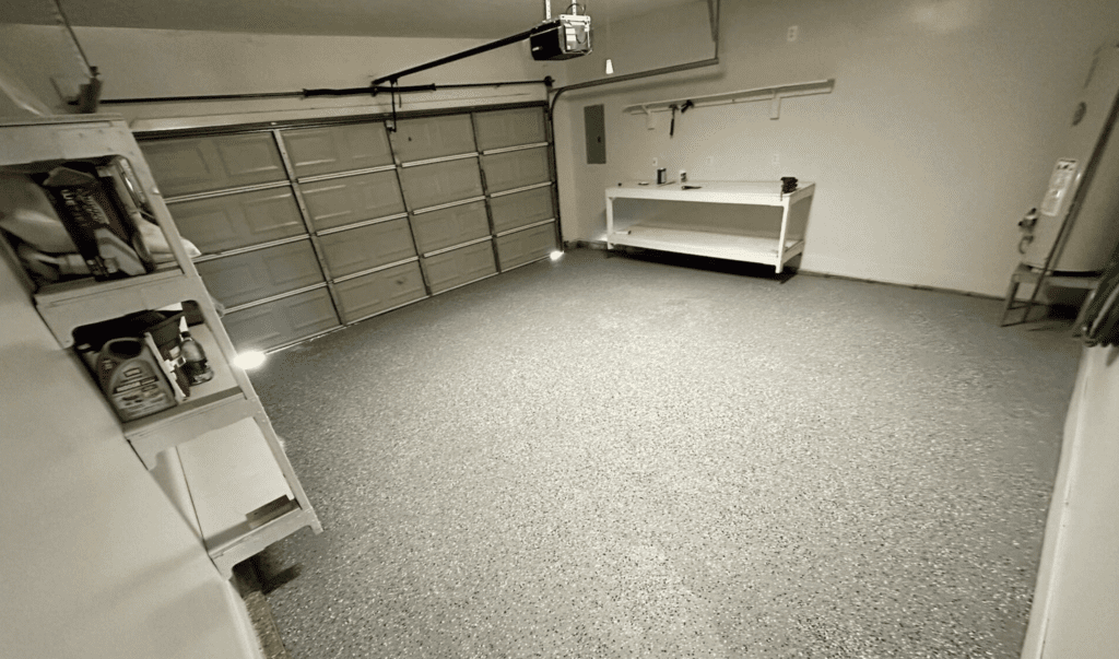 Clean, spacious garage with a closed door and workbench.