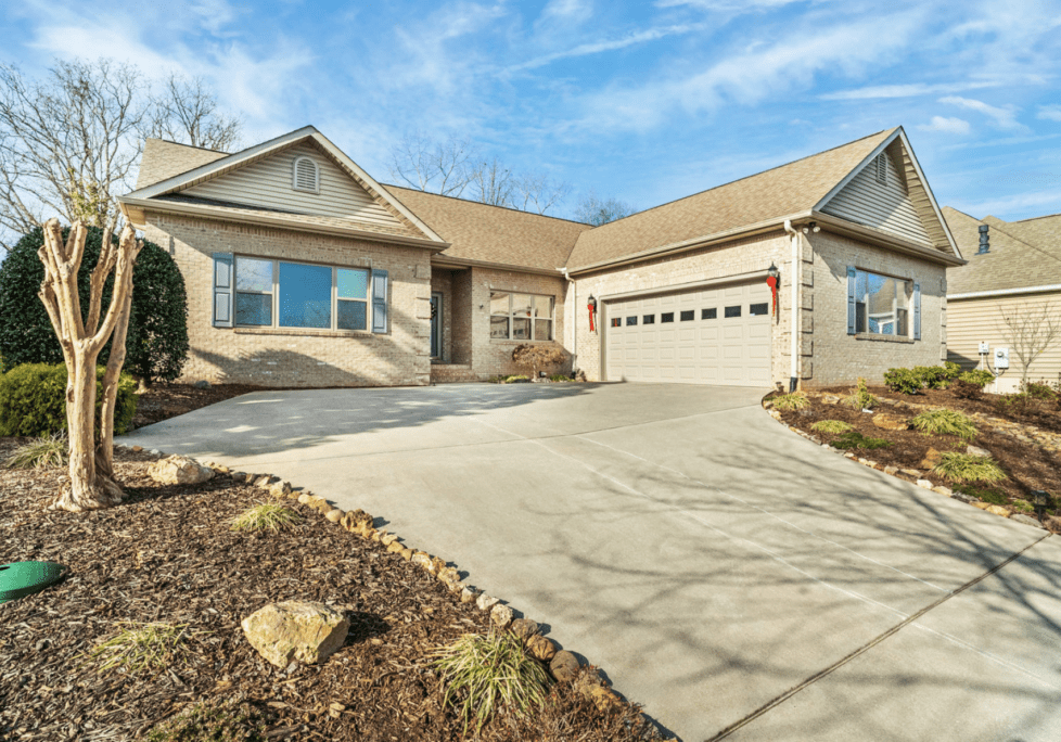 Modern single-story house with a spacious driveway and attached garage.