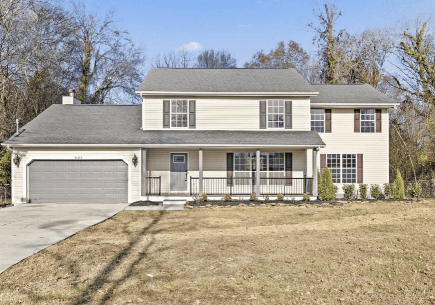 A two-story suburban house with a front porch and garage.